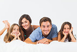 Cute family lying on a bed together