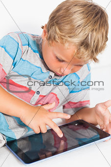 Happy boy touching a tablet