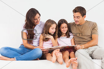 Family reading a story on a sofa
