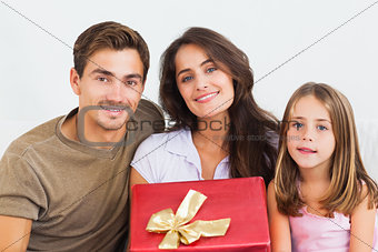 Father and his daughter offering a gift to her mother