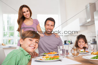 Family looking at the camera at dinner time