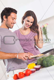 Happy couple making dinner