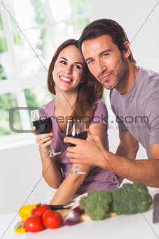 Smiling couple with wine and vegetables