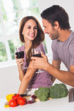 Smiling lovers with wine and vegetables