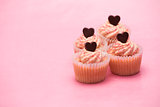 Four valentines cupcakes with chocolate hearts