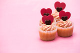 Four valentines cupcakes with heart decorations
