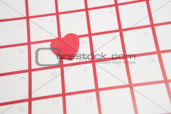 Pink heart resting on valentines day on calendar