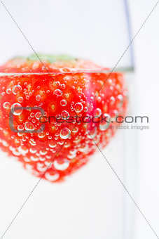 Strawberry floating in champagne