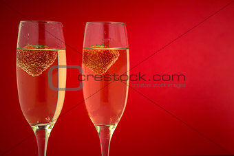 Two glasses of champagne with strawberries