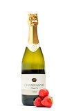 Bottle of champagne with three strawberries