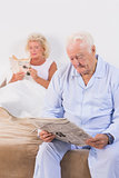Aged couple reading on the bed