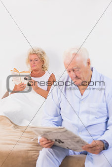 Elderly couple reading on the bed