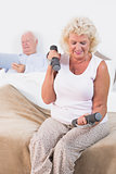 Aged woman lifting hand weights