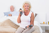 Elderly woman exercising with hand weights