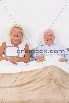 Aged couple lying on the bed