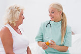 Home nurse and patient talking together about medicine