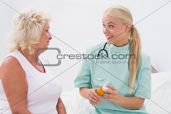 Home nurse and patient talking together about medicine