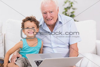 Grandfather and grandson with a laptop