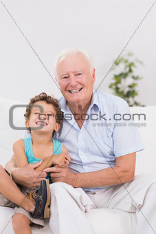 Grandfather and grandson sitting on the sofa