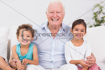 Grandfather and children sitting on the sofa