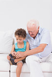 Grandson tying his shoelaces with his grandfather