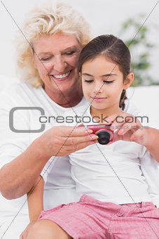 Granddaughter and grandmother looking at pictures