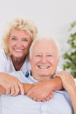 Cheerful old couple portrait hugging