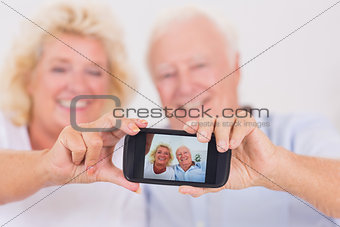 Old couple taking pictures with a smartphone