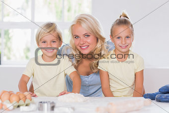 Family smiling at the camera with the baking tools