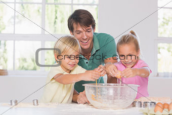 Children breaking eggs into a bowl
