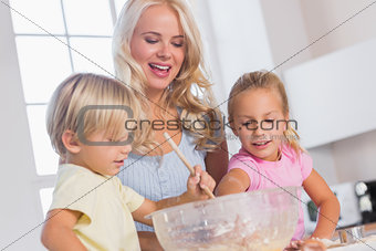 Children mixing the dough bowl with spoon