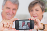 Old couple taking a picture of themselves