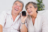 Old couple listening to a smartphone
