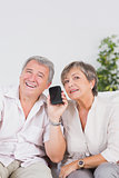 Old lovers listening to a smartphone
