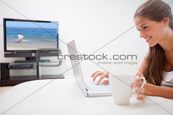 Woman with a cup surfing the internet