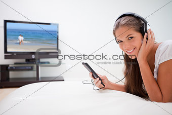 Smiling woman listening to music in the living room