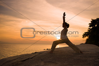 silhouette girl posing yoga on beautiful beach during sunset