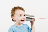 friendly child listening to tin can phone