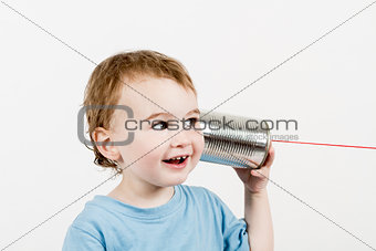 friendly child listening to tin can phone
