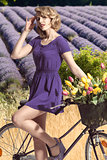 portrait of pretty girl with bicycle . outdoor field lavander