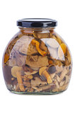 Glass jar with assorted marinated mushrooms