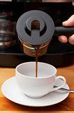 Closeup of coffee being poured into cup
