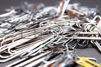 Paper clips lying in a pile on a desk