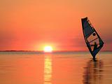 Silhouette of a windsurfer on waves of a gulf on a sunset 3