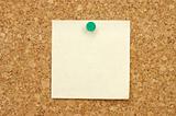Post-it note with pushpin on corkboard