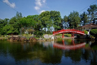 red bridge, blue sky and tree in the parks