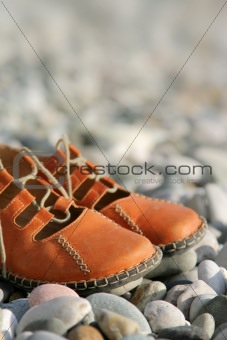 sandals on a pebbled beach