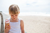 Girl with ice cream near beach