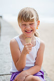 Girl with ice cream near beach