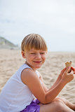 Happy girl with ice cream on beach